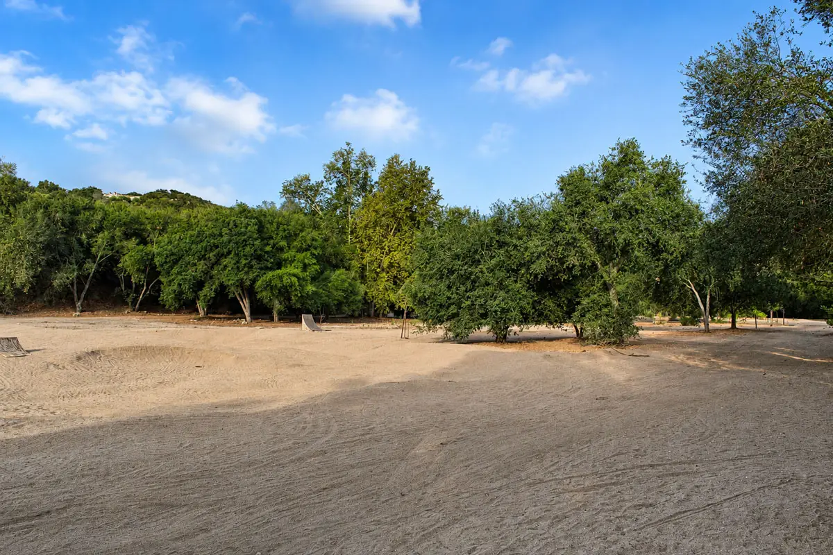 An undeveloped portion of Jesmond Dene Park is slated to become the John Masson Memorial Bike Park. The bike park will be built in the tree-lined area in the background, while the dirt area in the foreground, often used by remote-control car drivers, will remain. Photo by Samantha Nelson