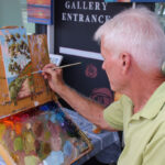 Jim McConlogue paints a coastal scene at LeucadiART Walk. Photo by Cameron Adams