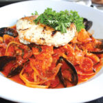 Francisco’s Seafood Brodetto is a hearty fish stew brimming with scallops, shrimp, clams, mussels and calamari in a garlic, wine and tomato broth. Photo by Rico Cassoni