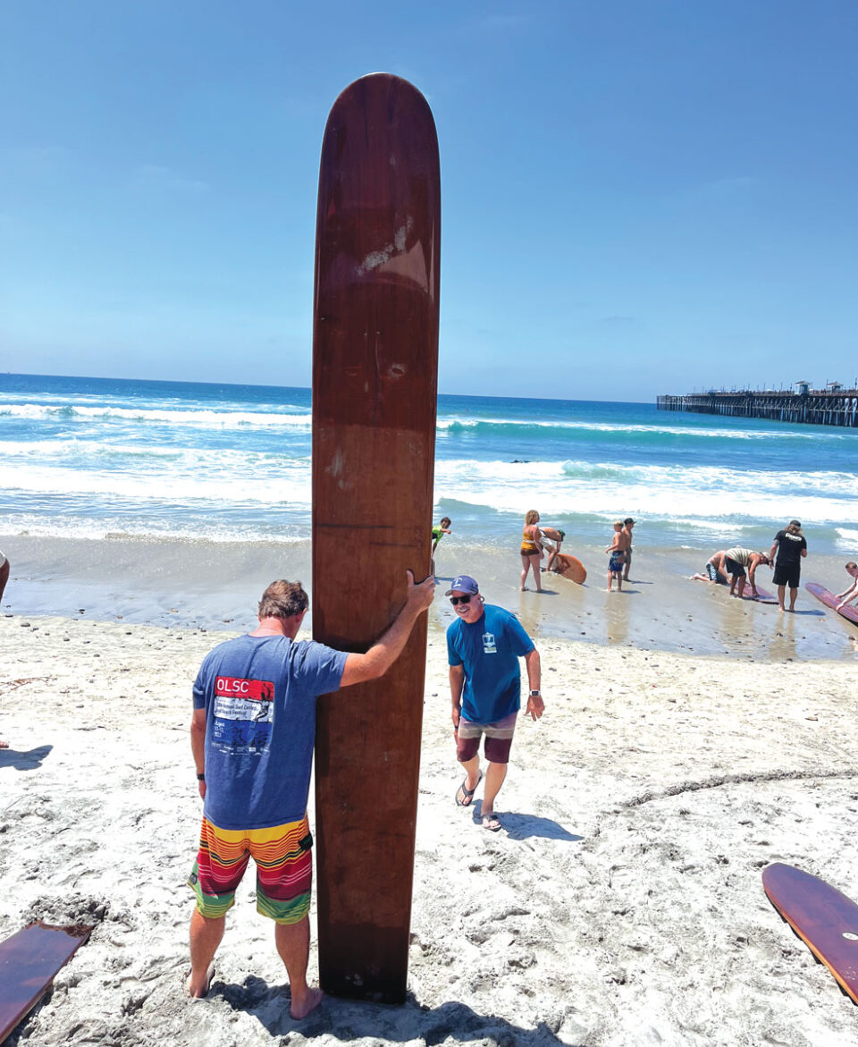 Bingo Cosby Jr. prepares to paddle out on a board that reflects surfing's Hawaiian roots. Photo by Chris Ahrens