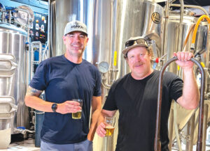 Russell "Woody" Johnson, left, and Mike Aubuchon finish up a brew day with a quality check test. Photo by Jeff Spanier