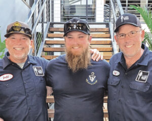 Author and podcast co-host Jeff Spanier, left, and co-host Jeff Riccitelli, right, flank Stone Liberty Station head brewer Kris Ketcham. Courtesy photo