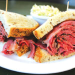 Milton’s most popular sandwich, with pastrami piled high on fresh house-made rye bread. Photo by Rico Cassoni