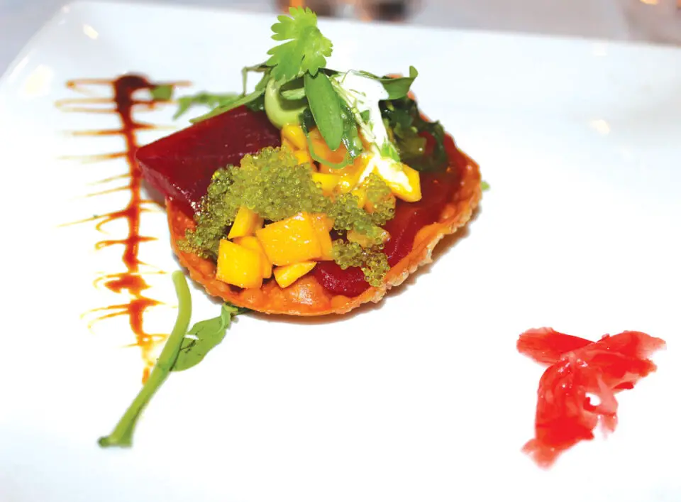 Hand-cut bluefin tuna with fresh mango and creamy avocado garnished with pickled ginger and wasabi tobiko nestled on a crisp wonton shell paired with Inglenook Blanc. Photo by Rico Cassoni