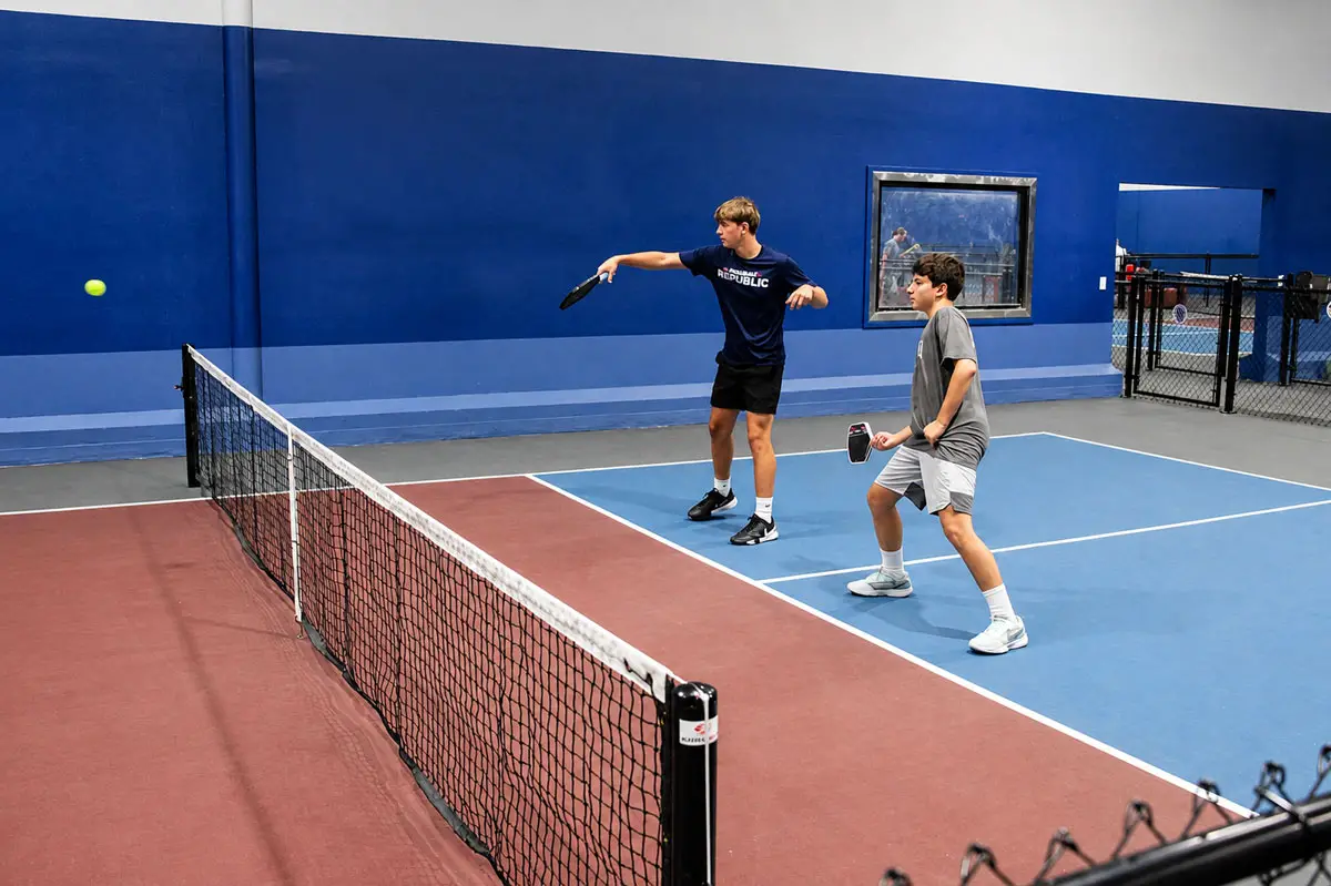 Two young players compete on one of the indoor courts at Pickleball Republic Carlsbad South, a new facility featuring 10 indoor and two outdoor courts. Photo by Cameron Adams