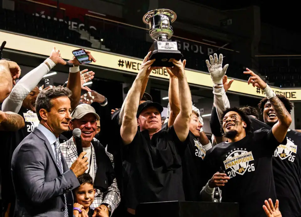Arizona Rattlers head coach Kevin Guy hoists the Western Conference Championship trophy alongside his team after a 43-37 victory over the San Diego Strike Force on Sunday at Frontwave Arena in Oceanside. Courtesy photo/Rattlers