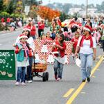 Members of a Girl Scouts troop march in a past San Marcos Holiday Parade. The annual tradition faces an uncertain future as the city searches for a new organizer. Courtesy photo/Kiwanis