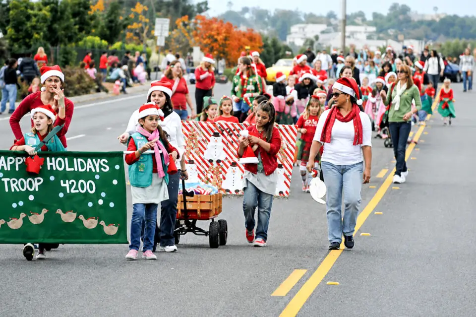 Members of a Girl Scouts troop march in a past San Marcos Holiday Parade. The annual tradition faces an uncertain future as the city searches for a new organizer. Courtesy photo/Kiwanis