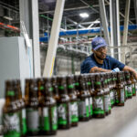 A Stone Brewing employee works along the bottling line at the company’s production facility. Courtesy photo/Stone