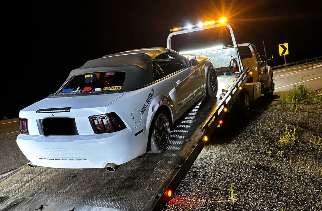 A white vehicle is loaded onto a tow truck during a joint San Diego police and California Highway Patrol operation targeting illegal street racing and sideshows. Courtesy photo/CHP