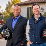 33 Property Management founders Rich Brocchini and Baryic Hunter with firefighter helmets outside a North County home