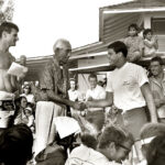 Circa 1965, Duke Kahanamoku congratulates runner-up Paul Strauch at the Duke surfing contest. Photo by Leo Hetzel