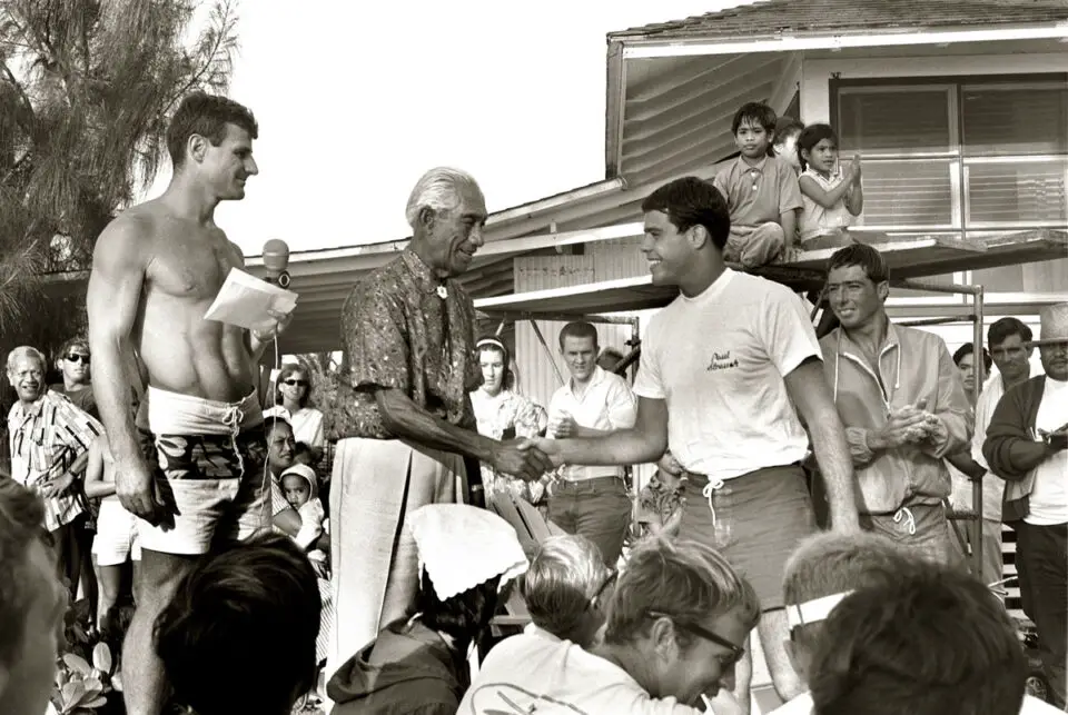 Circa 1965, Duke Kahanamoku congratulates runner-up Paul Strauch at the Duke surfing contest. Photo by Leo Hetzel
