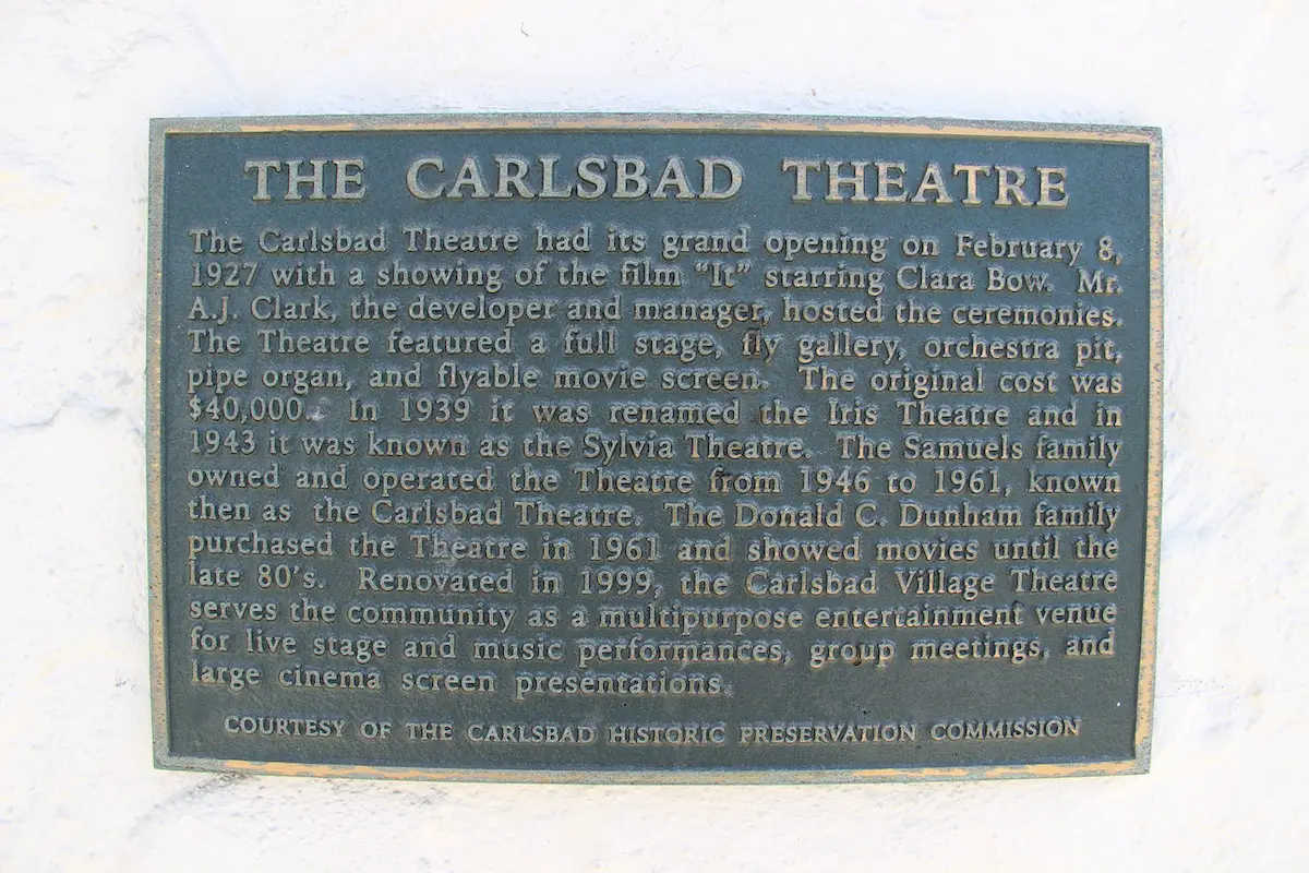 A historical placard details the Carlsbad Theatre’s past, dating to its opening in 1927. Photo by Cameron Adams