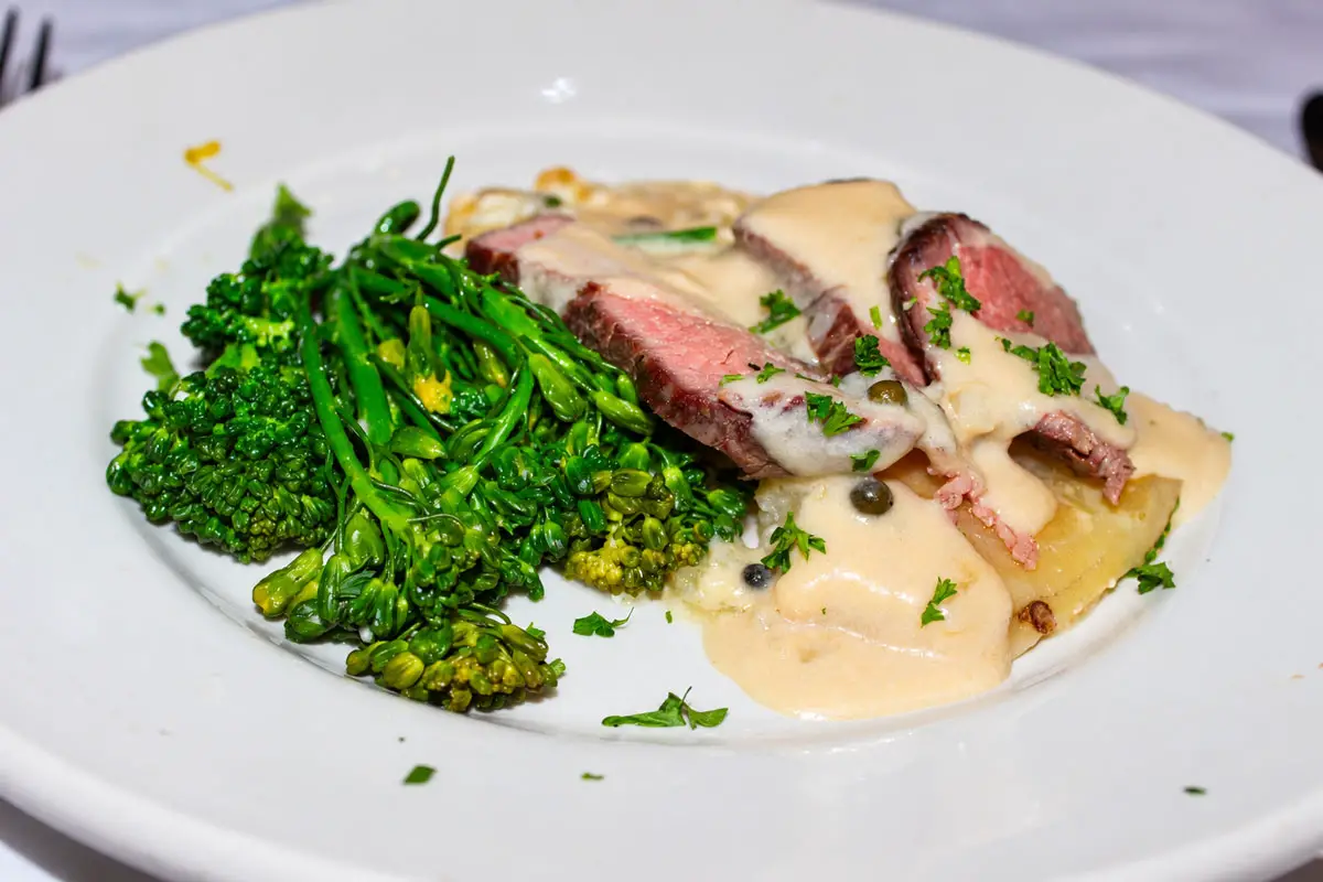 Grilled Bistro beef tenderloin, potato gratin, and garlic broccolini paired with 2024 8 Years in the Desert. Photo by Rico Cassoni