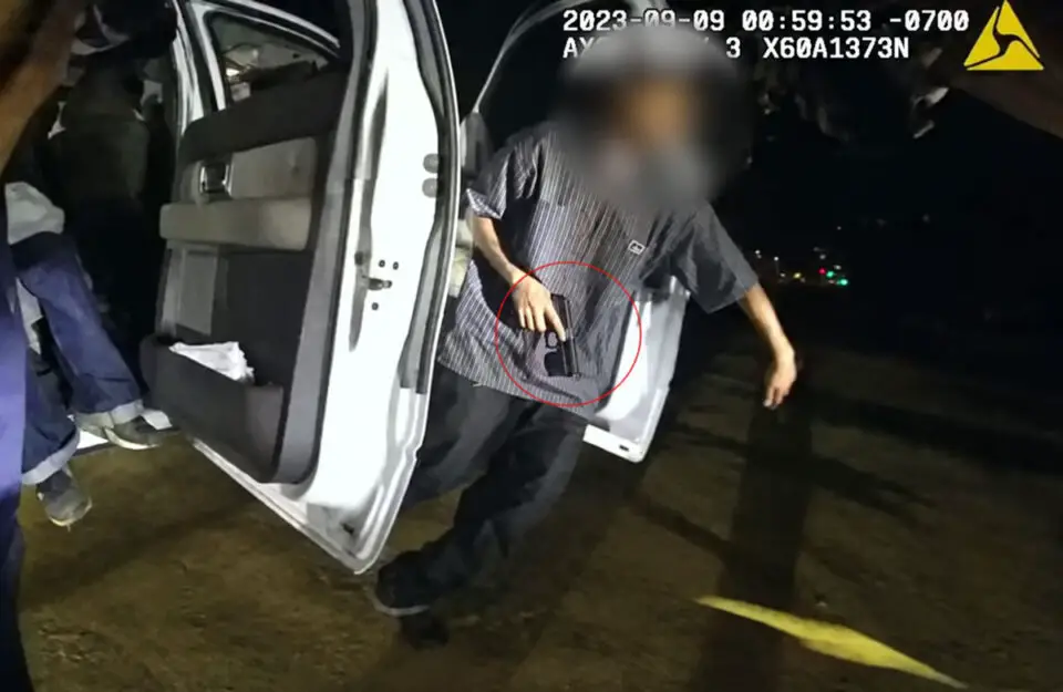 A screenshot depicting the juvenile male with a ghost gun in his hand attempting to flee from Carlsbad Police officers. Screenshot/CPD