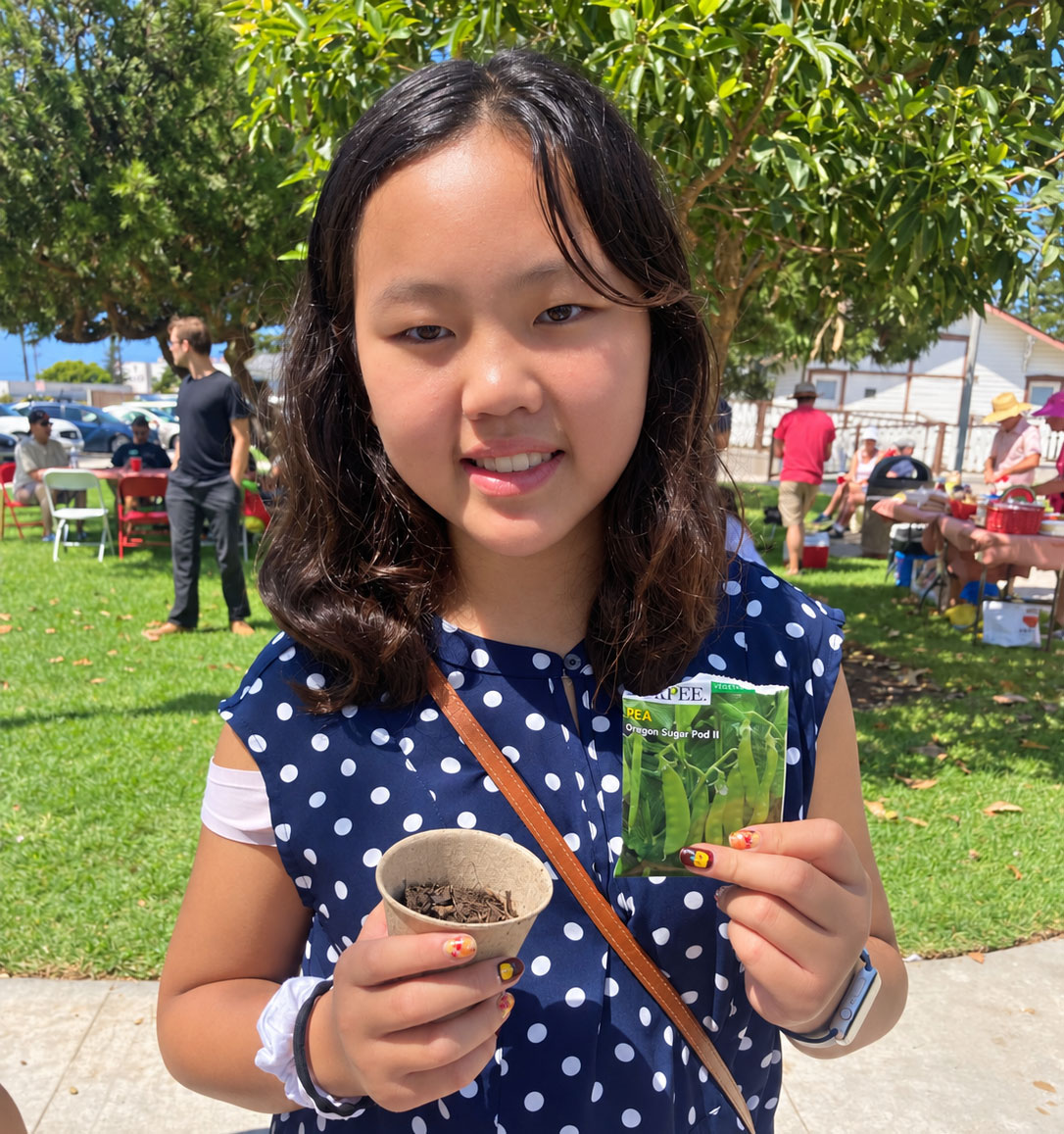 Jena Hwang of Carlsbad enjoys learning how to plant seeds on Sept. 13 at the Carlsbad Watermelon Festival. Photo by Jano Nightingale