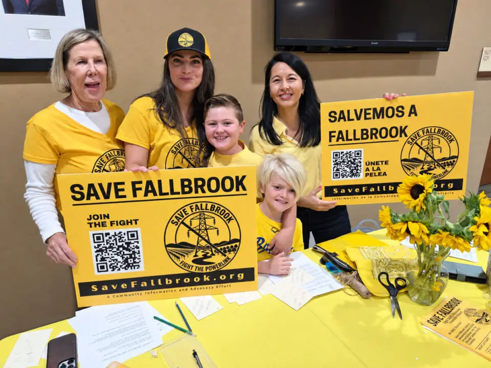 Fallbrook residents hold signs opposing SDG&E’s proposed Golden Pacific Powerlink during a California Public Utilities Commission hearing Sept. 17 at the San Marcos Civic Center. Photo by Jim Trageser