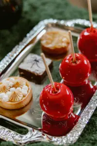 Red candy apples and pastries on a silver tray for Halloween tea at Four Seasons Residence Club Aviara in Carlsbad.