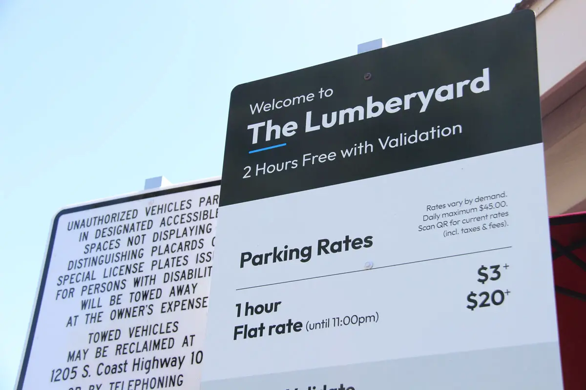 New signs at The Lumberyard in downtown Encinitas list proposed parking rates starting at $3 for one hour, with two hours free through validation at participating businesses. Photo by Jordan P. Ingram
