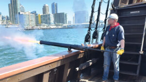 Maritime Museum of San Diego volunteer Alex Noscov fires the cannon (swivel gun) on the San Salvador as it returns to the dock in San Diego Bay. The guns were used for close-range defense. Noscov fired the guns three times during the four-hour sail. Photo by Laurie Brindle