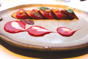 Citrus-cured tuna crudo with pluots (a plum/apricot hybrid), pink peppercorn and citrus yuzu citrus. Photo by Rico Cassoni