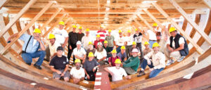 Maritime Museum shipwrights and volunteers stand in the frame of the hull of the San Salvador in April 2012. To test its seaworthiness, the replica was launched when only about 70% finished, according to Ray Ashley, president and CEO of the Maritime Museum for 30 years. Photo by Ted Walton