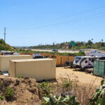 Shipping containers stand on a parcel zoned Rural Residential 2, which allows agricultural uses and low-density, single-family detached housing. Photo by Jordan P. Ingram