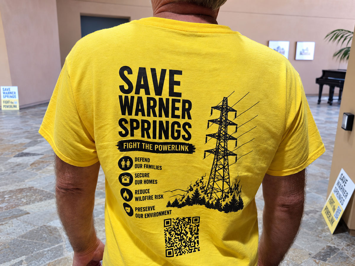 An opponent of SDG&E’s proposed Golden Pacific Powerlink wears a “Save Warner Springs” shirt during a California Public Utilities Commission hearing Sept. 17 in San Marcos. Photo by Jim Trageser