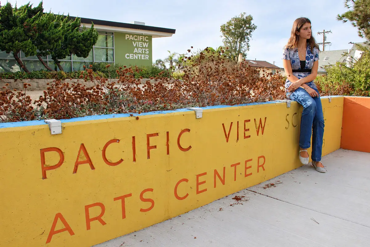 Sloane Donnelly poses in front of the Pacific View Arts Center. Photo by Cameron Adams