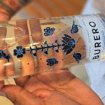 Saul Ocampo, a Marine veteran and founder of Ocampo Imports, holds a bottle of Burero Mezcal. Photo by Patrick Howell