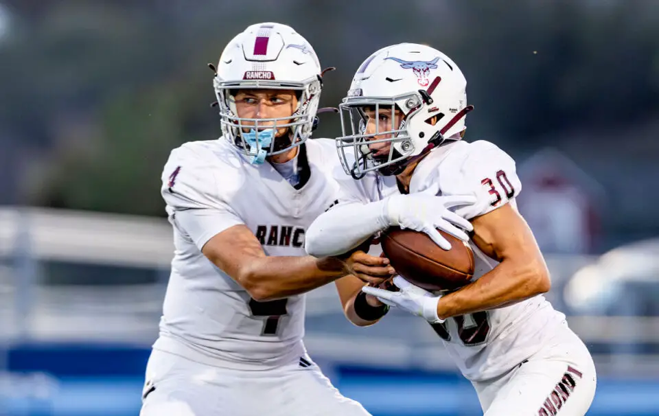 Longhorns quarterback Van Piercy hands the ball to running back Ean Perfect earlier this season. Photo by Michael Manzano
