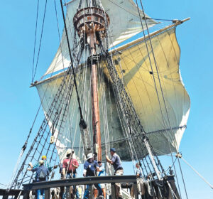 Some of the 15-volunteer crew aboard the San Salvador unfurl the foresail and the smaller fore topsail just after the galleon entered the waters beyond San Diego Bay. The replica measures nearly 115 feet from the tip to tip. The crow’s nest at the top of the mast served as a lookout point or, if the ship was in battle, a place from which to rain down arrows on an enemy vessel. Photo by Laurie Brindle