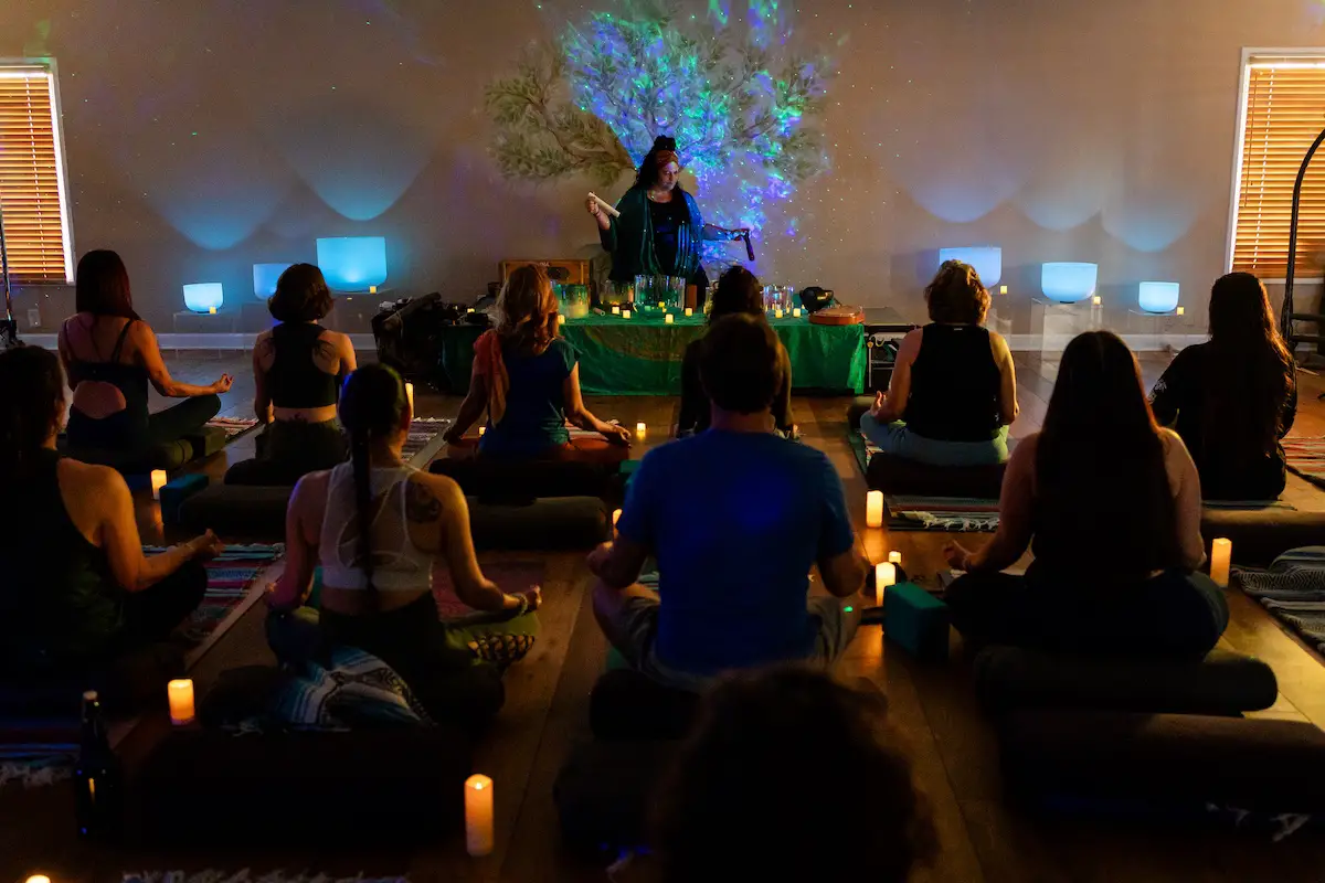 Participants practice yoga in a softly lit classroom at Soul of Yoga in Encinitas, which is celebrating its 25th anniversary. Courtesy photo/Soul of Yoga