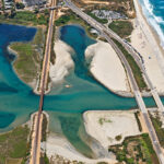 Rail tracks cross Batiquitos Lagoon, where crews will resume work this weekend as part of a project to add a second track and replace the aging rail bridge. Photo courtesy of SANDAG