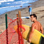 A surfer makes his way to the shoreline on Oct. 15 at Beacon's Beach in Leucadia. Photo by Jordan P. Ingram