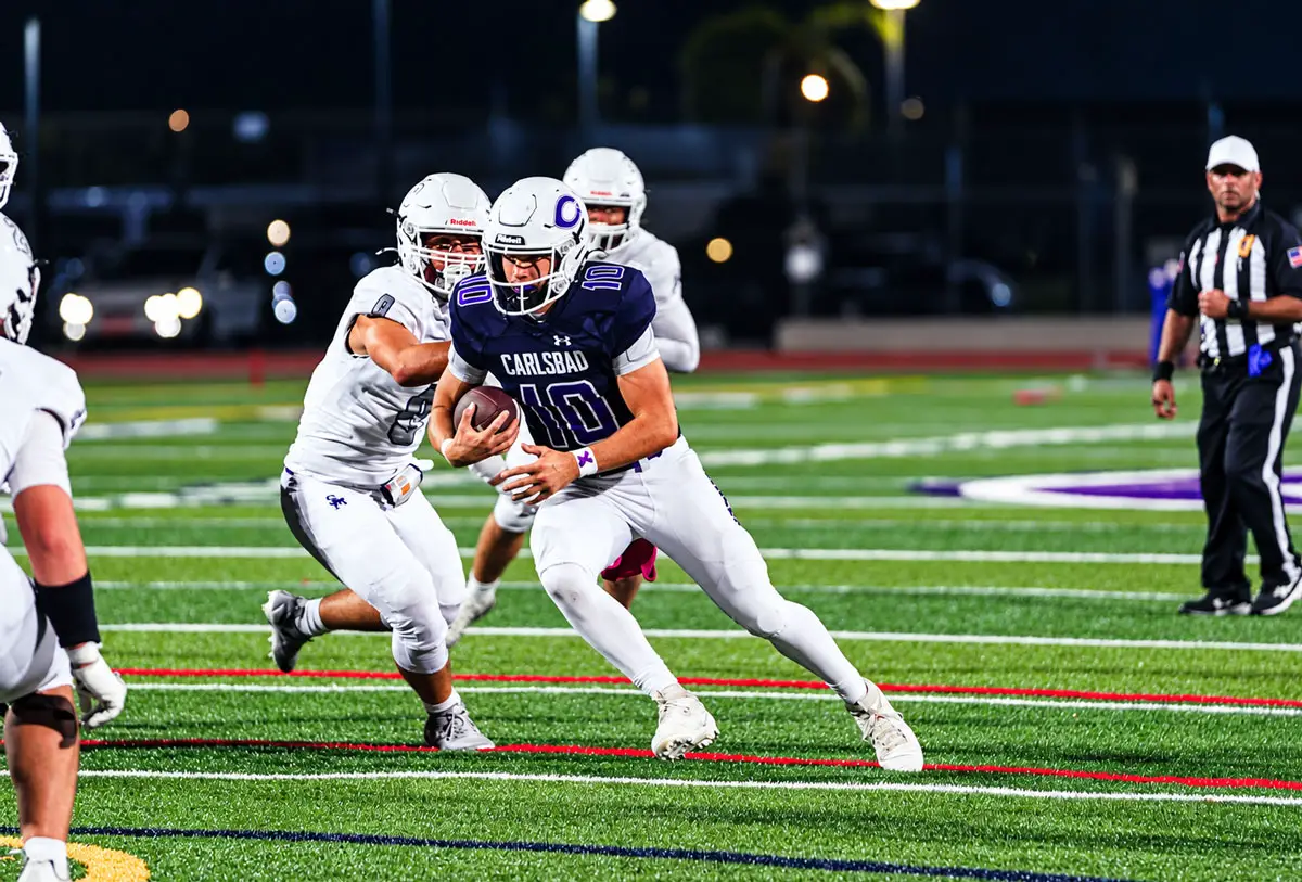Carlsbad quarterback Antonio D’Alessandro runs with the ball against San Marcos on Friday night. D’Alessandro threw for 158 yards and two touchdowns in the Lancers’ 42-26 victory, keeping Carlsbad unbeaten at 8-0. Photo by Julian Liner