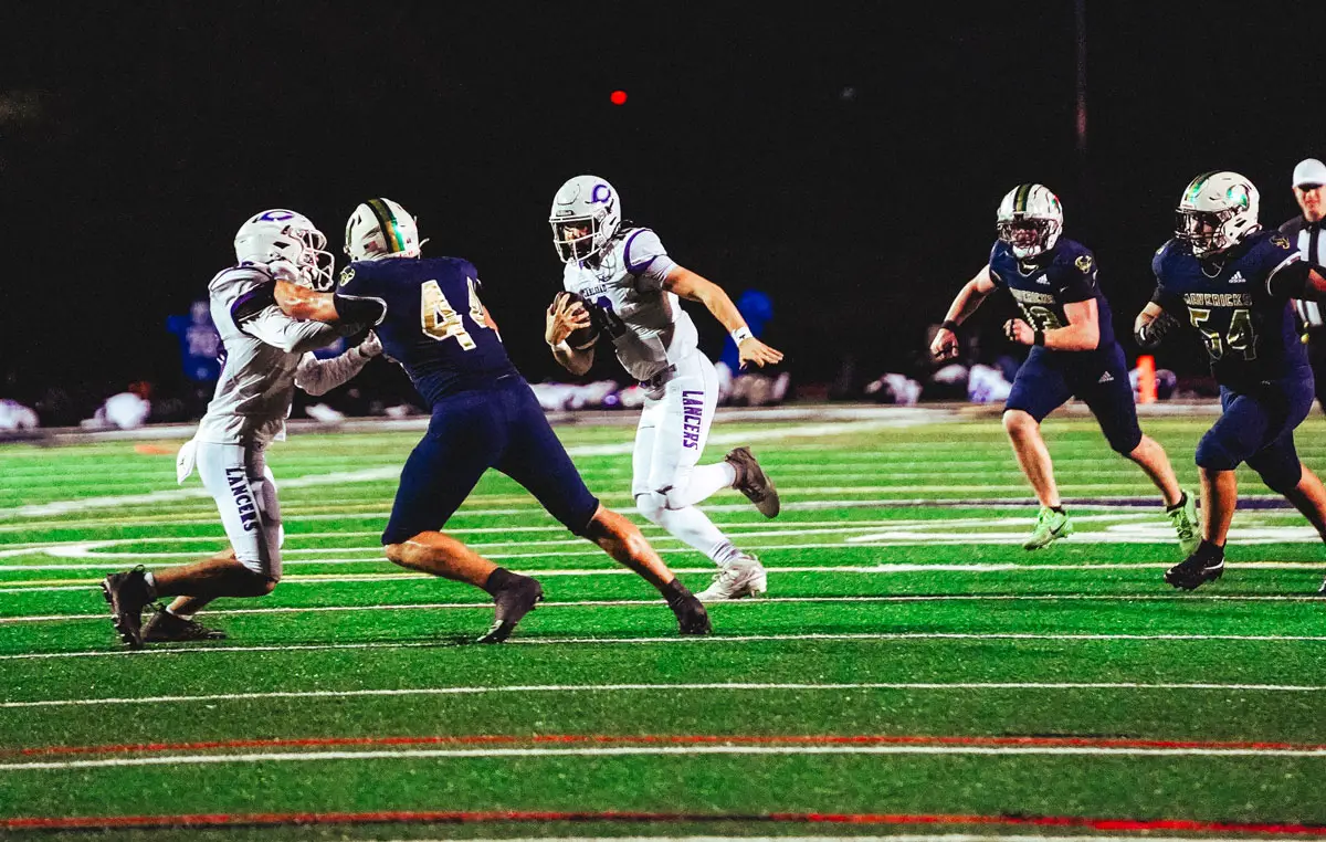 Carlsbad players compete against La Costa Canyon on Friday in a rivalry matchup. The Mavericks handed the Lancers their first loss of the season, 37-21. Photo by Julian Liner