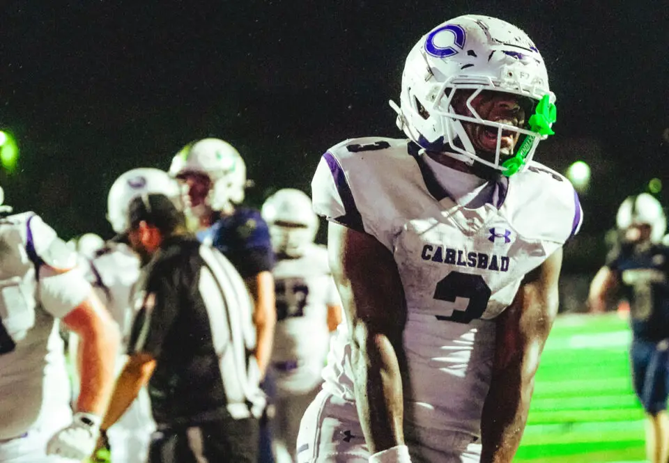Carlsbad players battle La Costa Canyon during Friday’s Avocado West League game. The Mavericks won 37-21. Photo by Julian Liner