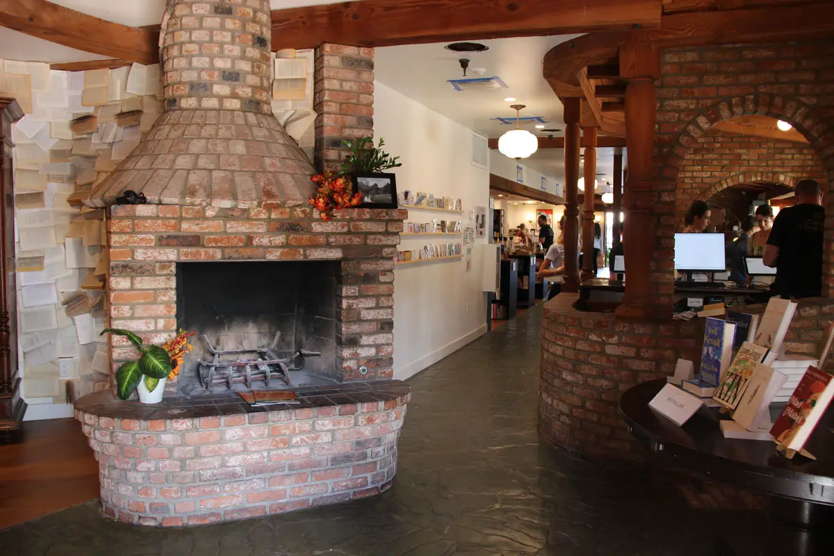 A brick fireplace and warm, inviting interior add to the old-world charm of Carlsbad Village Books, a family-run bookstore housed in a former Irish pub in the city's downtown village. Photo by Christopher Bacon