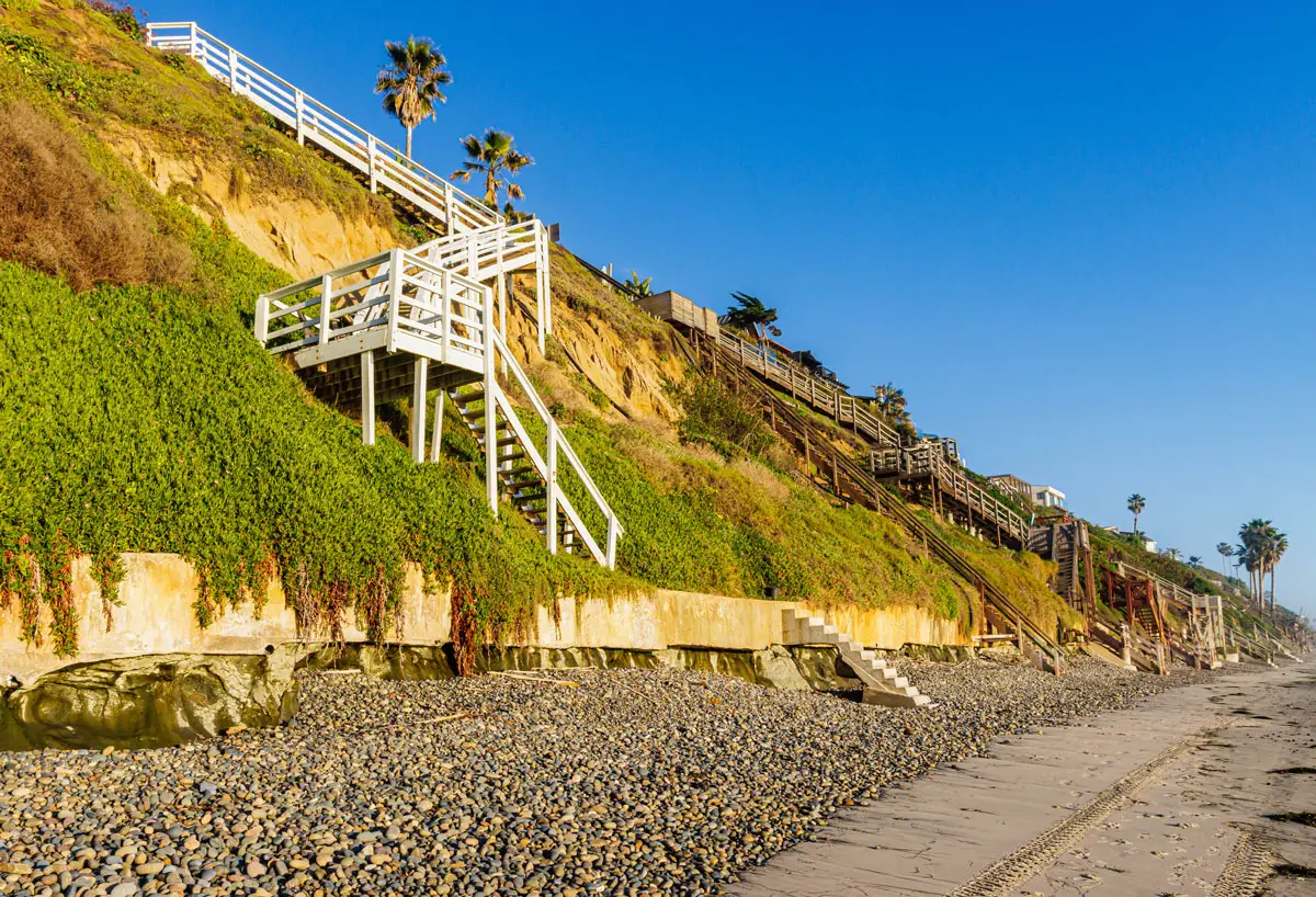 Cobblestones line the narrow shoreline beneath coastal bluffs at Grandview Beach in Leucadia. Photo by Billy McDonald