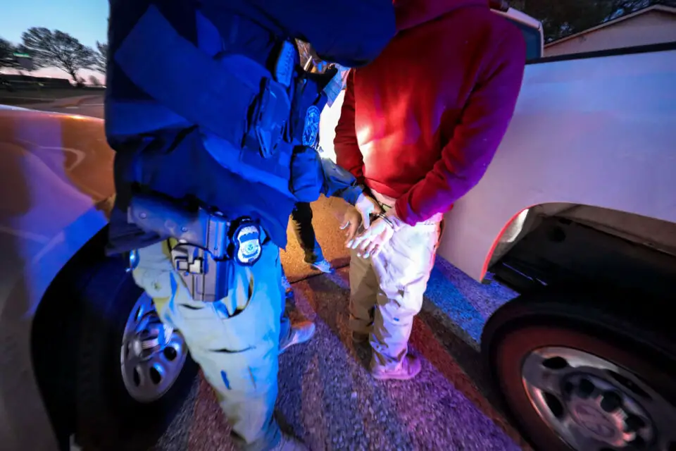 ICE agents take a person into custody. Reports of increased immigration enforcement across North County have prompted residents to organize neighborhood patrols and share community alerts. Courtesy photo/ICE