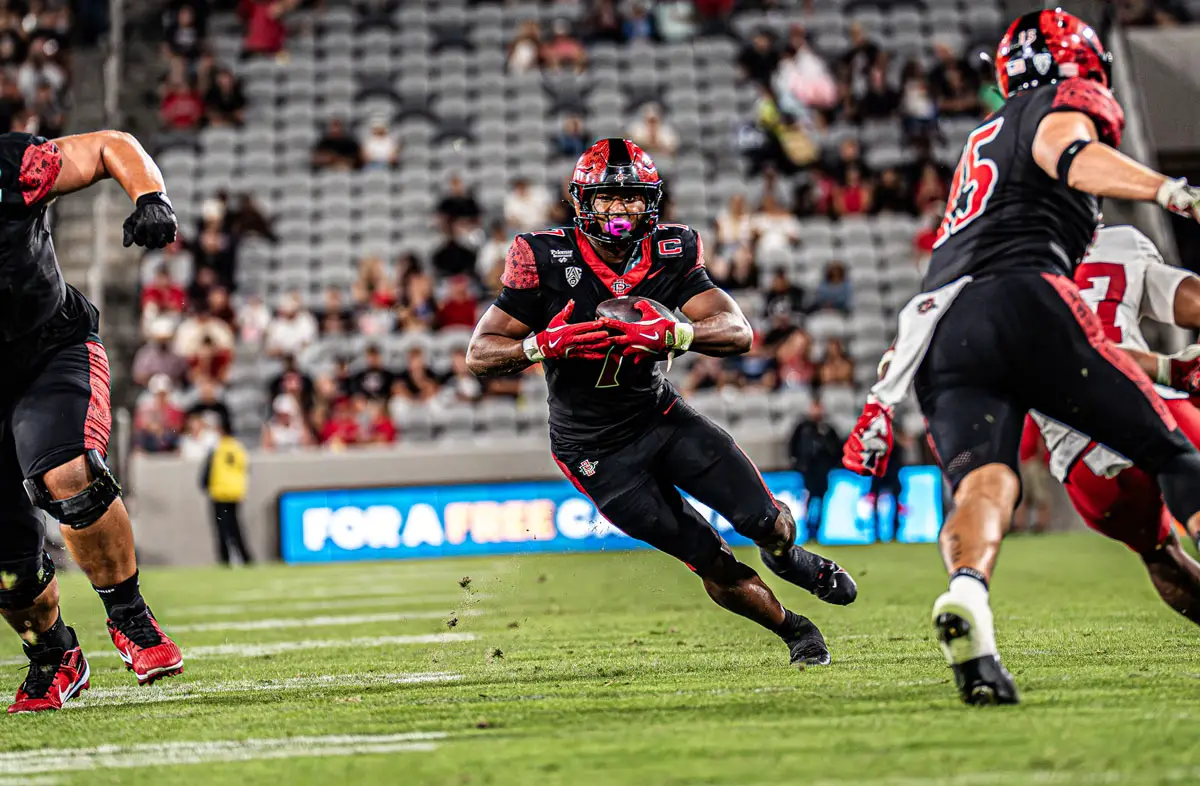 San Diego State’s Lucky Sutton recorded his seventh career 100-yard rushing game in Saturday’s 26-23 win over Fresno State. The Cathedral Catholic graduate finished with 119 yards on 18 carries as the Aztecs snapped a three-game losing streak. Photo by Isaac Angel