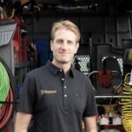 Colepepper Plumbing founder Mitch Kenney, a third-generation San Diego plumber, stands in front of his service van.