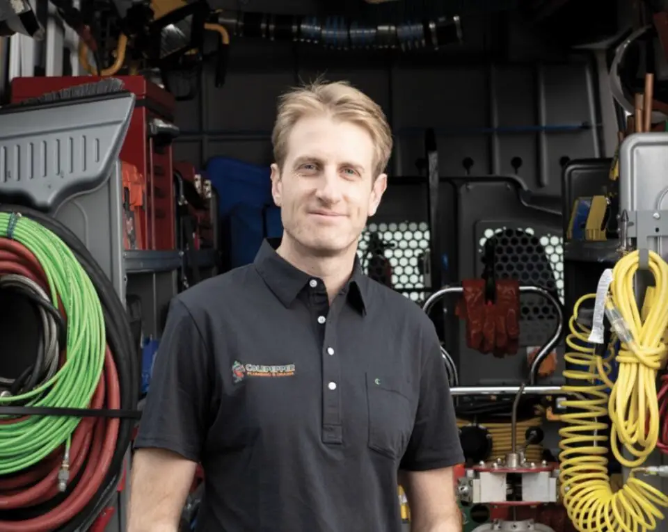 Colepepper Plumbing founder Mitch Kenney, a third-generation San Diego plumber, stands in front of his service van.