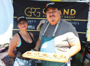 Grand Restaurant Group Chef Partner Alex Carballo and Melissa Carballo present duck mole tacos at the NOMADA booth. Photo by Rico Cassoni. Photo by Rico Cassoni