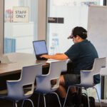 A student uses a laptop on the Palomar College campus in San Marcos as local community colleges weigh opportunities to expand their four-year degree offerings under new state laws. Courtesy photo/Palomar College