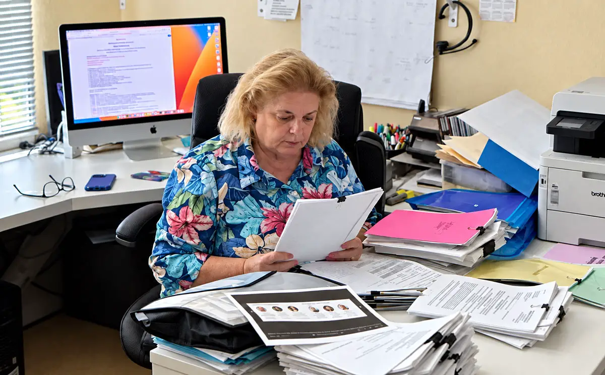 Retired contractor Pamela Begeal reviews lawsuits involving Christian Spicer and Infill Innovation at her Clairemont home office. Courtesy photo/Pamela Begeal