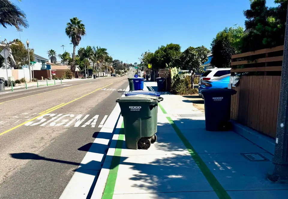 Trash cans on the sidewalk along Santa Fe Drive in Encinitas. Photo by Bill Rodenwald