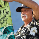 Larry Hidalgo holds a Gravity skateboard made in honor of his son, Shane Hidalgo, an Oceanside professional skateboarder who died in 2012. Photo by Samantha Nelson